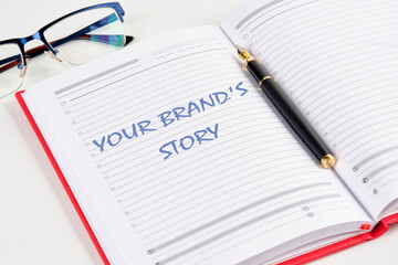 Business concept. Copy space. Concept words Your brands story the inscription in the notebook