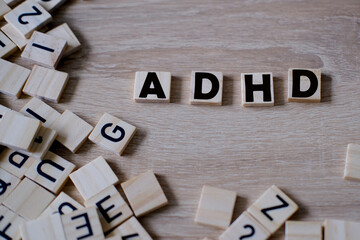 Attention deficit hyperactivity disorder, wooden alphabet blocks, word ADHD from letters, support for child requires support and understanding to manage emotions