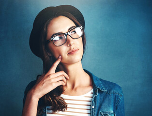 Woman, hat and glasses in studio with thinking of idea for problem solving, solution or planning...