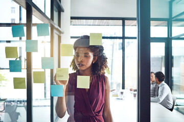 Writing, planning and thinking business woman in office for schedule, calendar or coaching idea research. Agenda, storyboard or manager with sticky note for training, improvement or target objectives