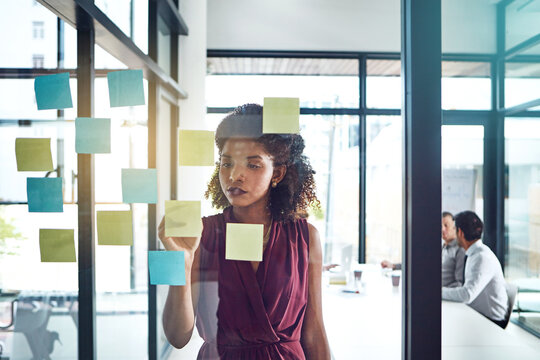 Writing, planning and thinking business woman in office for schedule, calendar or coaching idea research. Agenda, storyboard or manager with sticky note for training, improvement or target objectives