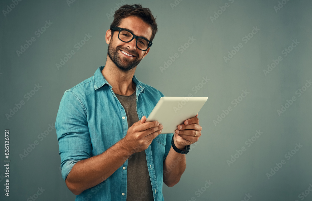 Aufkleber Man, studio and portrait with tablet and glasses, career with software programming in London. Male creative, space or gray background with happiness for digital job, mobile app or website development