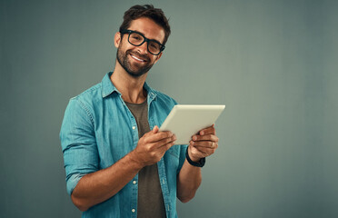 Man, studio and portrait with tablet and glasses, career with software programming in London. Male...