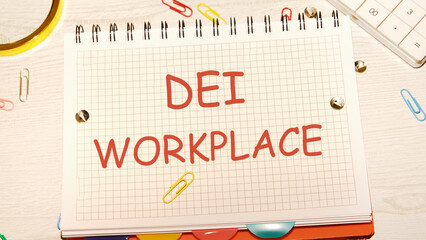 Business DEI diversity equity inclusion workplace concept. Copy space. Text DEI WORKPLACE written in a notebook on the desk of a businessman, manager