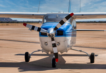 small commercial plane parked on the airstrip, close up of the propeller