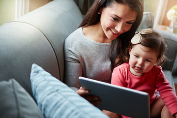 Happy, sofa and mother with baby on tablet for online games, watching videos and streaming movies....