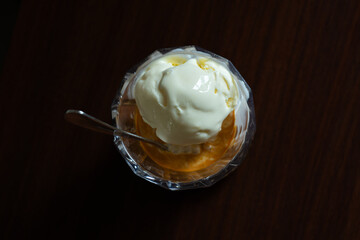 affogato dessert served on transparent glass, over dark wooden table background