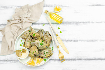 Traditional italian artichoke «alla romana», cooked carciofi vegetable. Olive oil, garlic, parsley