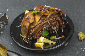 Delicious baked artichoke with parmesan cheese and pistachio. Olive oil, garlic, parsley and lemon