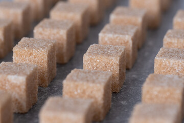 Straight rows of cane sugar cubes. Effect of dynamics.