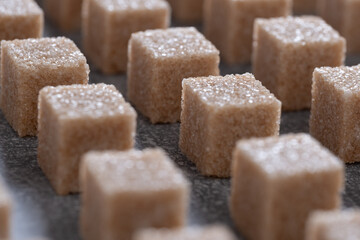 Straight rows of cane sugar cubes. Effect of dynamics.