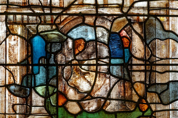 A multicolored abstract stained glass window in a church. Un vitrail abstrait multicolore. dans une...