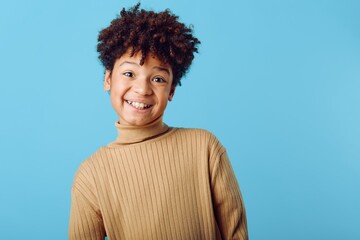 a young african american girl radiating joy and positivity in a cozy turtle neck sweater, smiling...