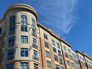 Modern apartment condo building against a blue sky with copy space