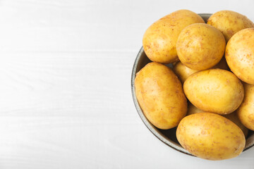 Young potatoes. Fresh potatoes  on a wooden background.Harvesting collection. organic, freshly dug potatoes. Agricultural background. Vegan. Vegetables.Place for text.Copy space