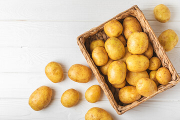 Young potatoes. Fresh potatoes  in wooden crate on a wooden background.Harvesting collection....