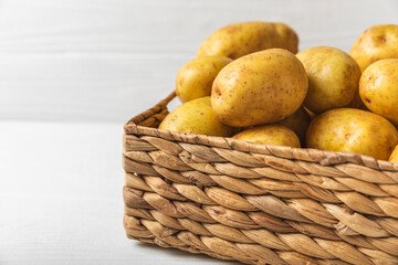 Young potatoes. Fresh potatoes  in wooden crate on a wooden background.Harvesting collection. organic, freshly dug potatoes. Agricultural background. Vegan. Vegetables.Place for text.Copy space