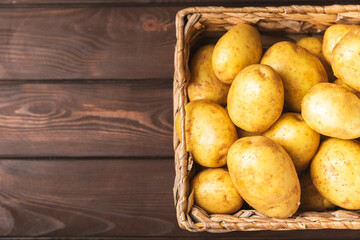 Young potatoes. Fresh potatoes  in wooden crate on a wooden background.Harvesting collection....