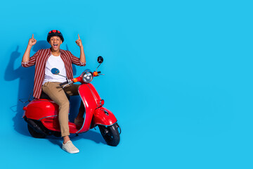 Full length photo of nice guy wear stylish t-shirt helmet sit on moped indicating at sale empty...
