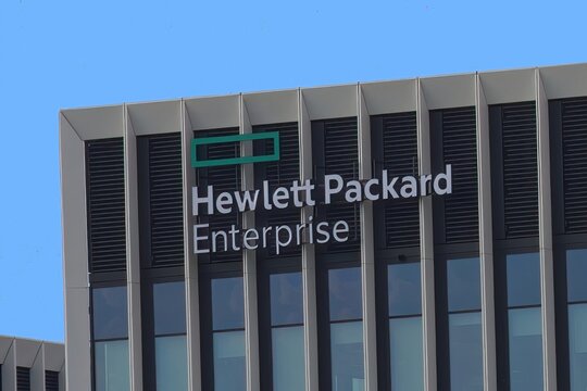 Closeup of Hewlett Packard Enterprise sign on modern building facade in the street.