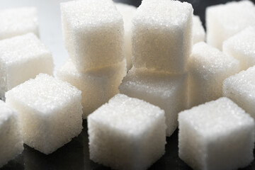 Refined sugar cubes on a black background. Close-up.
