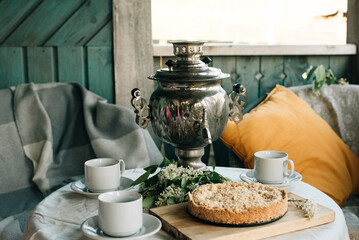 samovar, pie and cups on the table