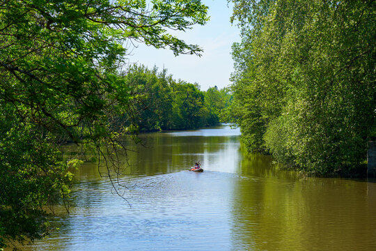 French locals kayaking on the river Loing in Grez-sur-Loing in the French department of Seine et Marne, Paris Region, France