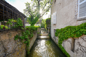 River La Cléry flowing at the foot of the houses of Ferrière-en-Gâtinais in the French department of Loiret, Centre Val de Loire, France