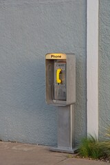 Classic pay phone on sidewall