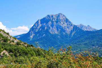 Obraz premium Peak of Morgon on the southern shore of the lake of Serre-Ponçon in the French Alps, a dammed artificial reservoir gathering the water of the Durance river