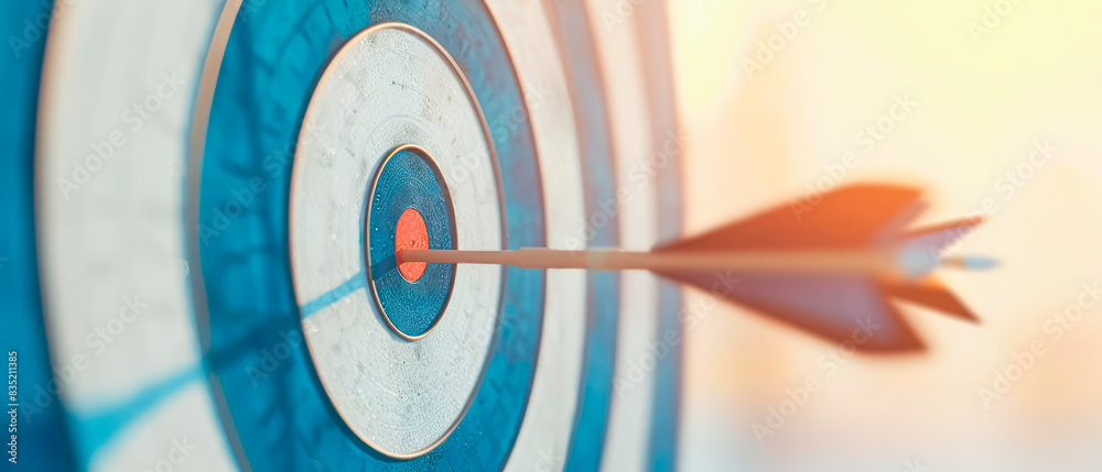 Poster close-up of an arrow hitting the bullseye on an archery target, concept of accuracy and goal achieve