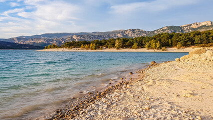 Pebbles beach on the shore of the lake of Sainte-Croix in Les Salles-sur-Verdon, department of Var in the south of France