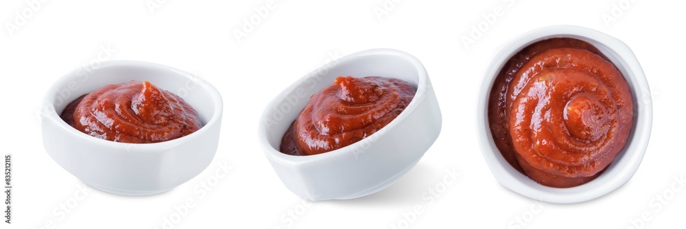 Wall mural ketchup sauce in a bowl on a white isolated background