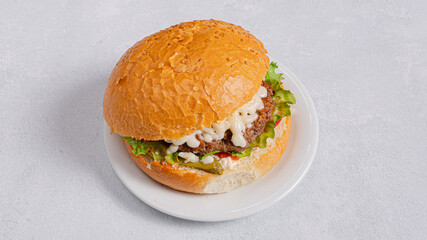Burger on plate isolated on white