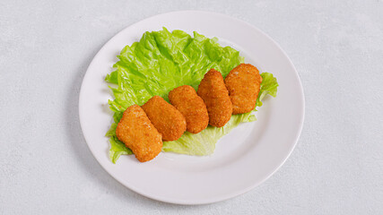 Chicken nuggets on plate top view