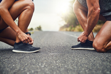 Couple, exercise and tie lace together on road for outdoor marathon, running and training as team....