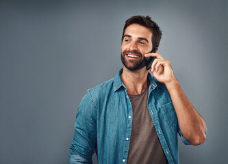 Happy man, fashion and phone call in studio with style, cheerful on mobile in gray background. Male...