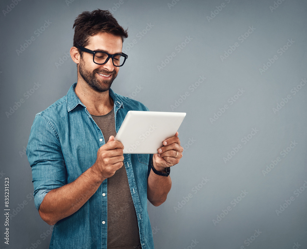 Poster Man, studio and review with tablet and glasses, career with software programming in London. Male creative, ebook and gray background with happiness for digital job, mobile app or website development
