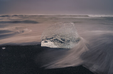 astract-shaped block of ice formed by water with trails from the holas © algaru57
