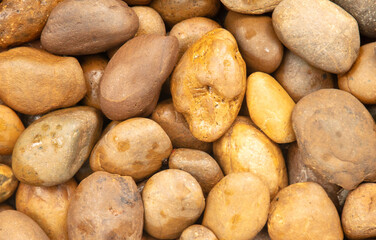 Round stones in the wall as an abstract background. Texture