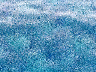 Raindrops on blue pool water. Background