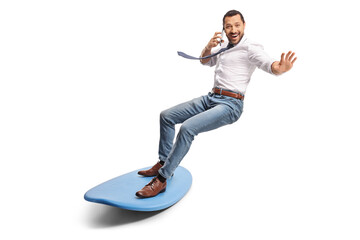 Man making a phone call and riding a surfboard
