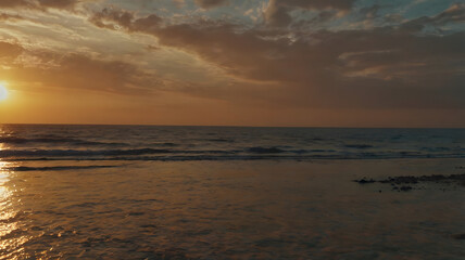 Twilight Glow: Sun Setting Over the Ocean