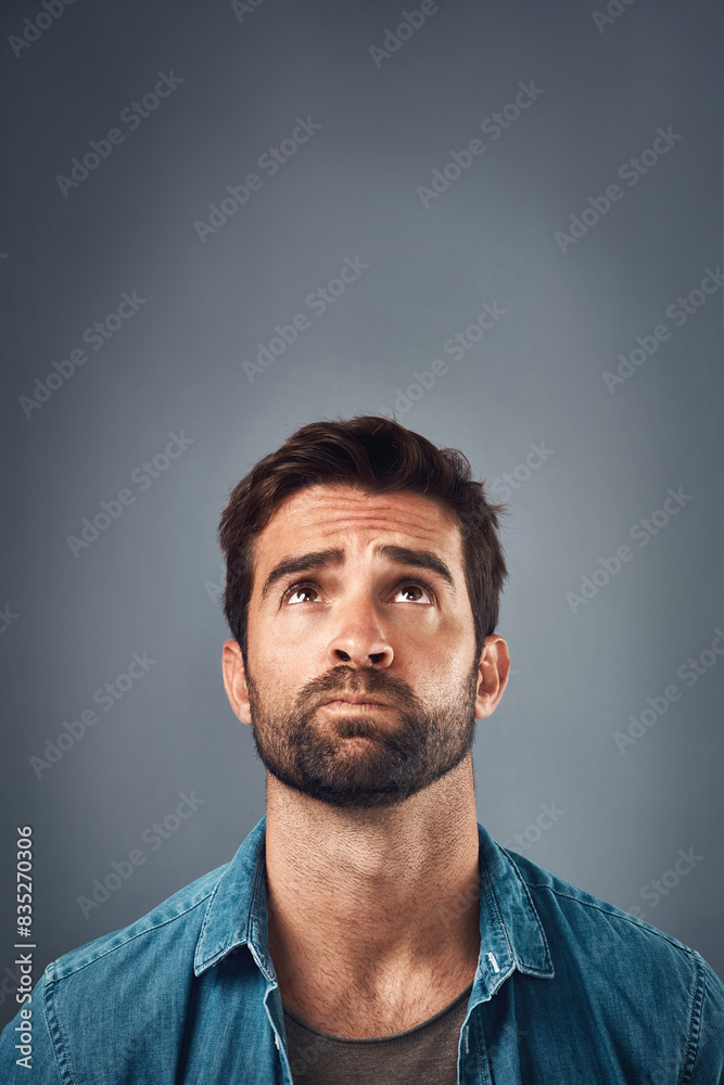 Poster Ideas, thinking and man with decision, confused and problem solving on grey studio background. Frustrated, person and model with questions, mockup space and solution with doubt, choice and remember