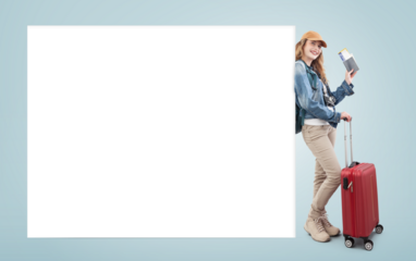 Happy young woman tourist traveling with trolley suitcase showing passport and flight ticket, isolated on blue background with a blank billboard. Advertising banner with copy space for travel agency