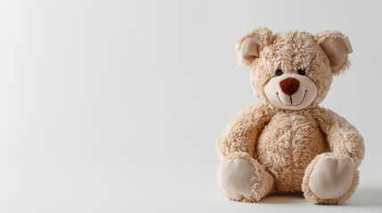 Obraz premium Plush brown toy bear sitting against a white background. Childhood companion. Concept of childhood, comfort, nostalgia, innocence. Copy space