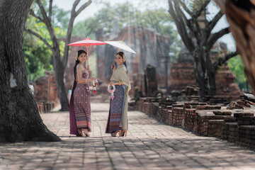 archaeological site temple country. person in Thai traditional with umbrella in Ayutthaya ,Thailand.