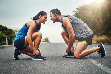 Fitness, runner couple and tie shoes in road for cardio, workout, endurance training or marathon....