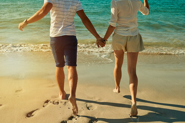 Beach, holding hands and couple with love, closeup and vacation for honeymoon, romance and...