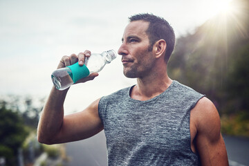 Thinking, athlete and man drinking water on break to hydrate or relax for healthy energy in...